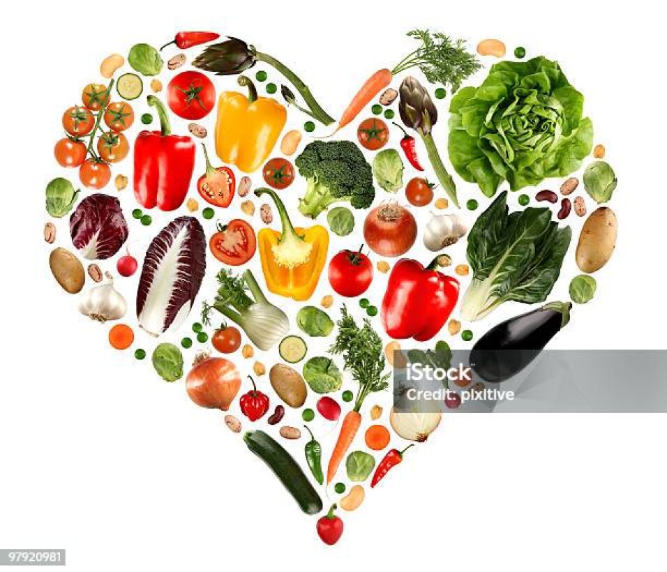 An heart maked with various vegetables isolated on white.